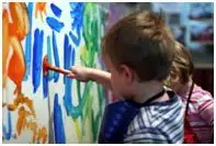 A person is painting on the wall.