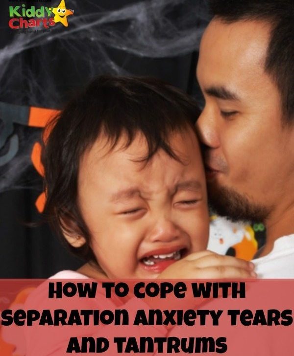 A loving mother kisses their toddler son's cheek as he reads a poster about coping with separation anxiety, indoors.