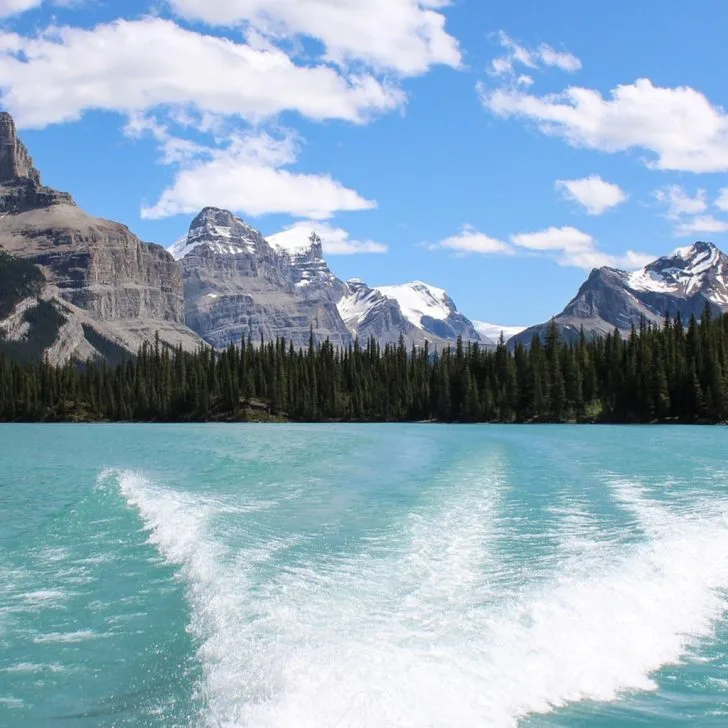 The mountains stand in the background of the body of water.