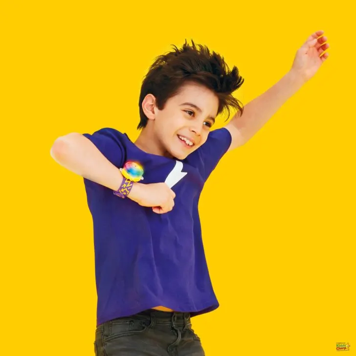 A young person with a bright yellow elbow patch is smiling happily.