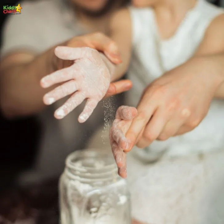 A person in a wedding dress is cutting their thumb nail with their finger as the bride holds their hand indoors.