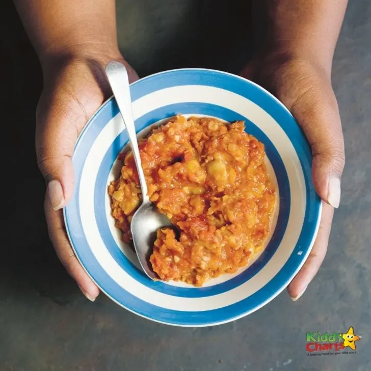 A person is holding a bowl of food.