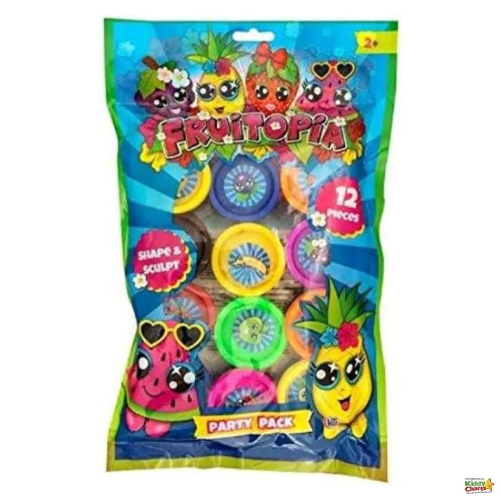 This image shows a colorful package labeled "Fruitopia" with 12 pieces of playdough, some adorned with fruit-themed cartoon characters, marked for ages 2+.