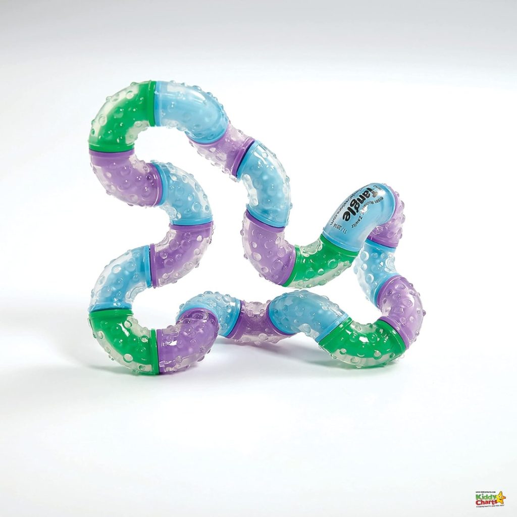 This image depicts a colorful, bendable, children's teething toy made of interconnected segments in shades of green, purple, and blue.