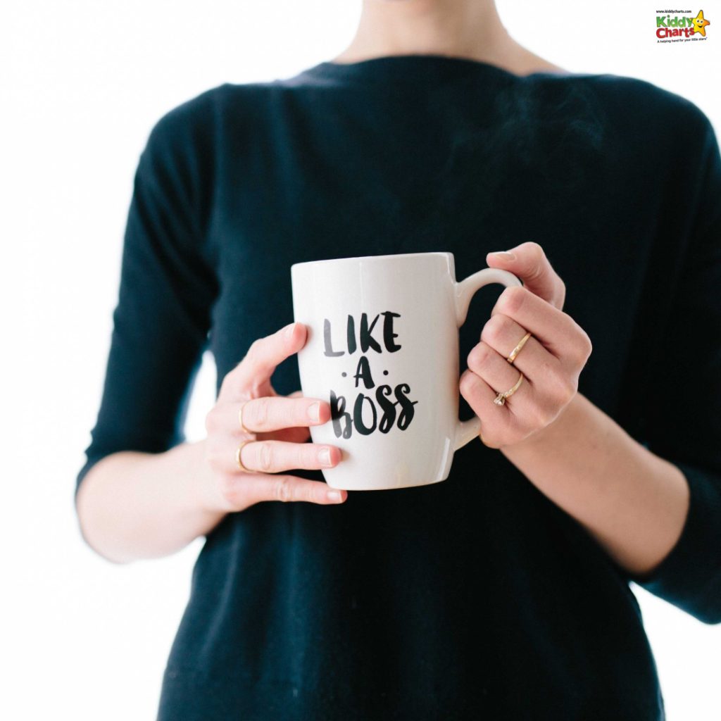 A person is holding a white mug with the phrase "LIKE A BOSS" written on it, against a white background. Steam rises from the mug.